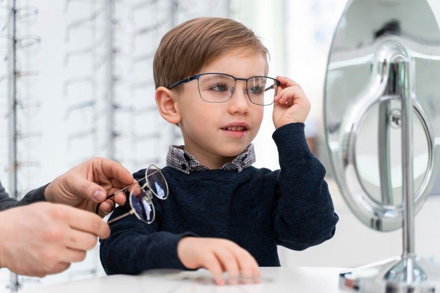 boy trying out an eyeglasses frame